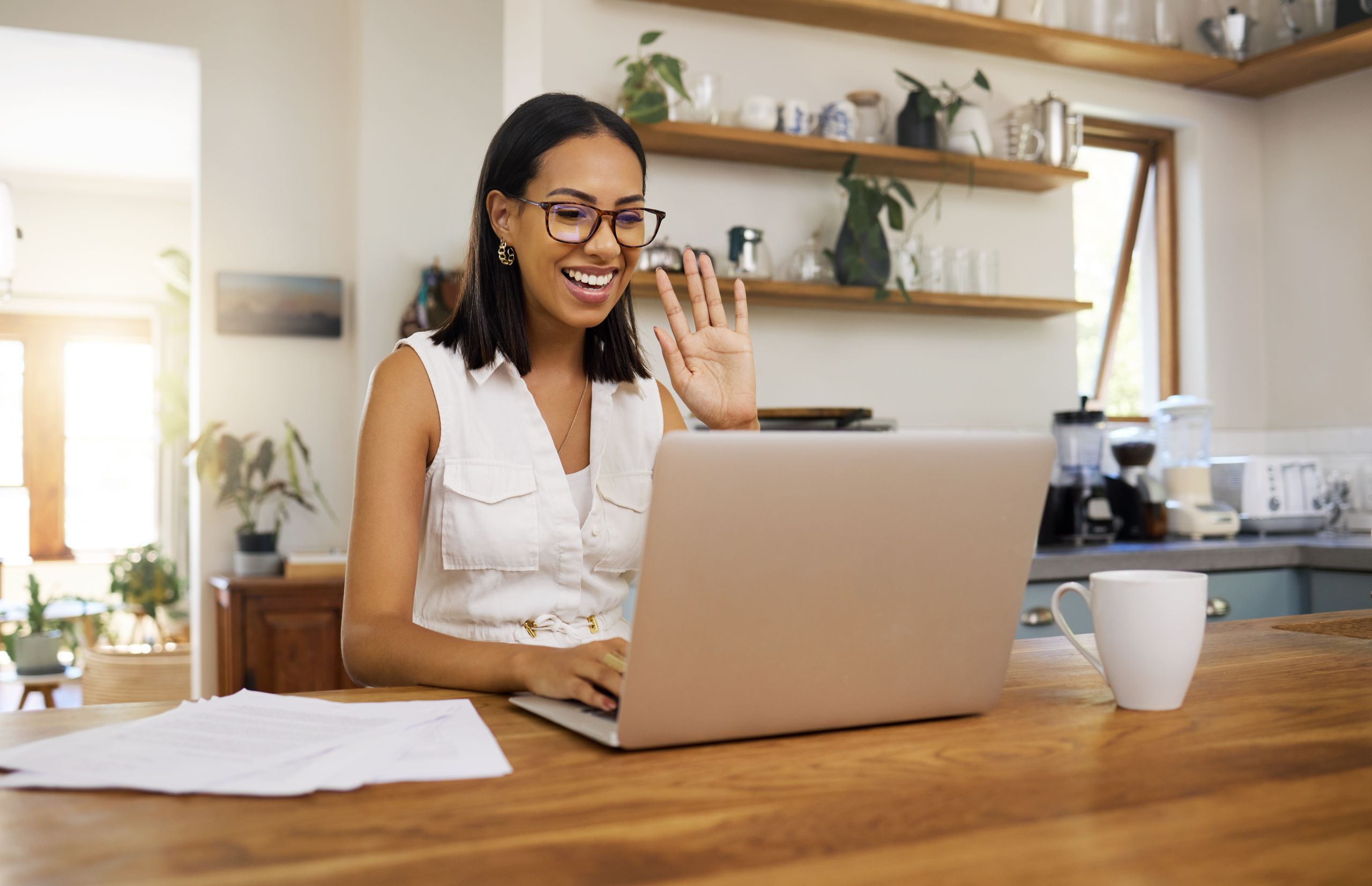 Laptop webinar, woman or video conference training on online zoom call meeting in home office or house room interior. Smile, happy and happy remote worker with wave on tech recruitment interview.