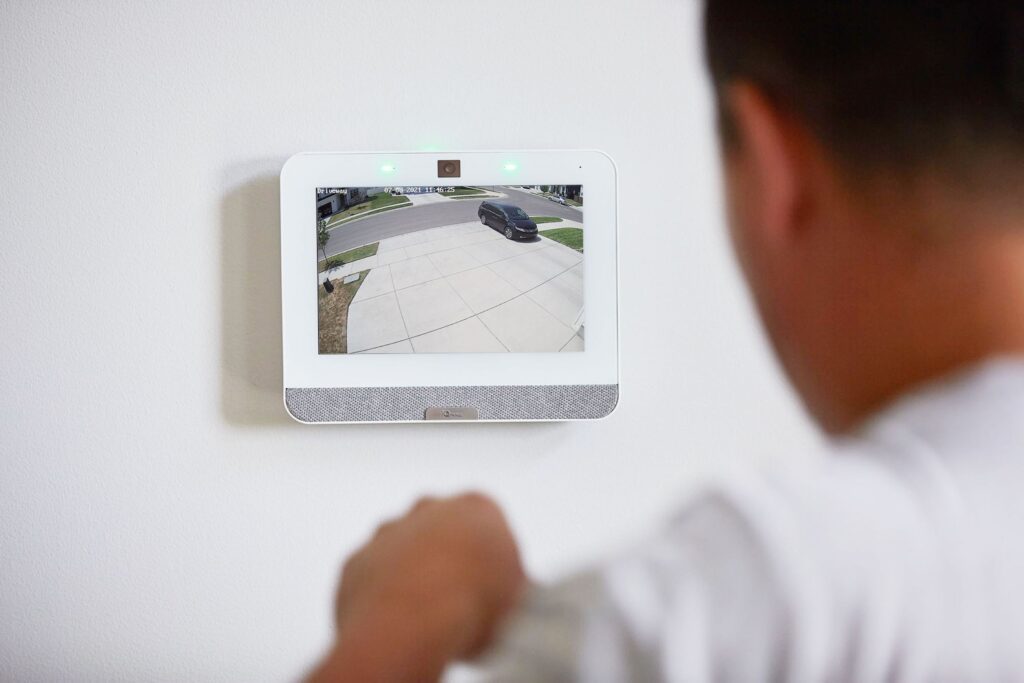 Home security panel showing live view of home exterior